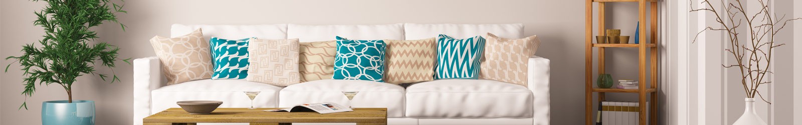 A bright living room with a white sofa and patterned cushions
