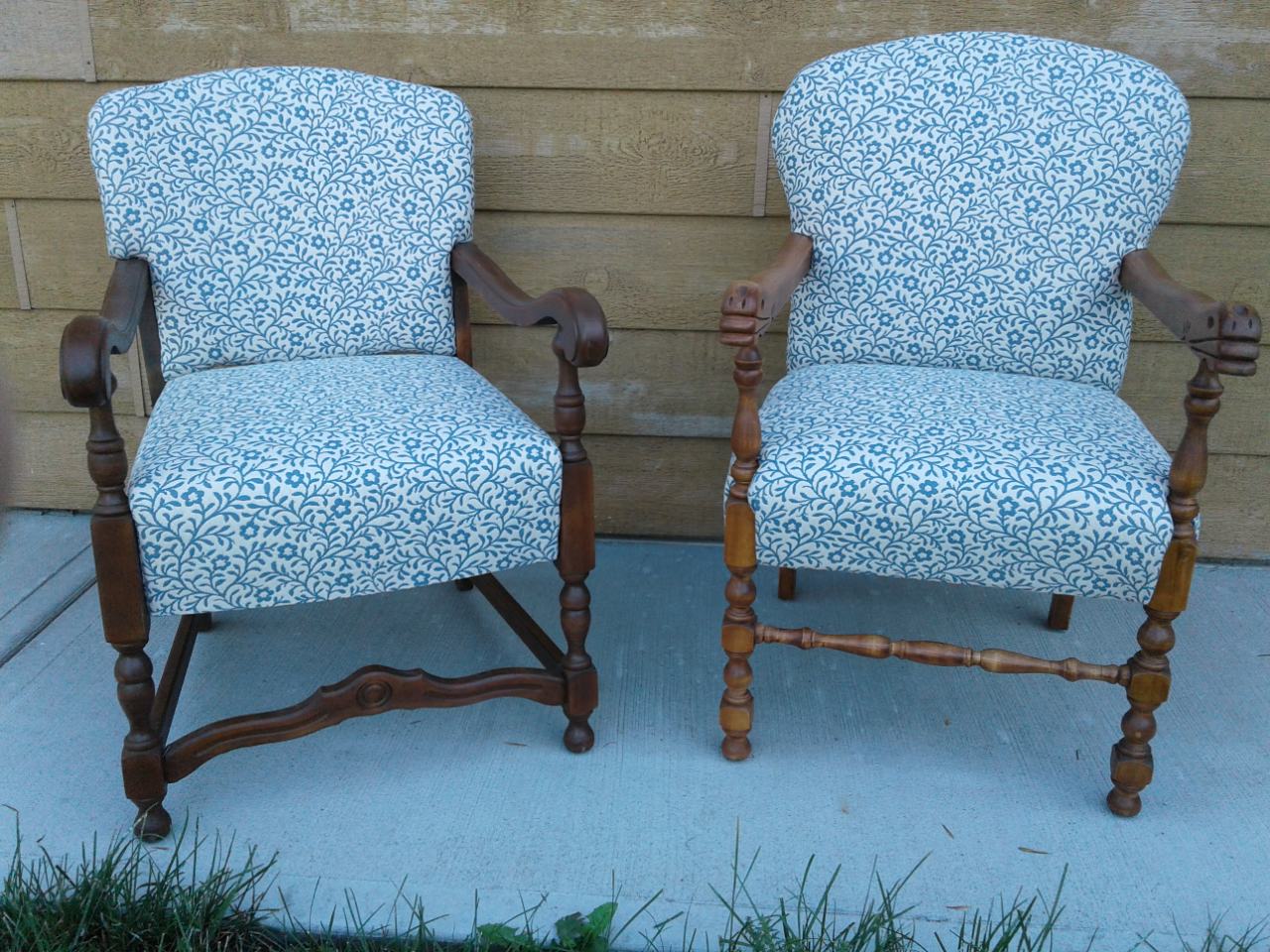Two wooden armchairs with blue and white floral upholstery